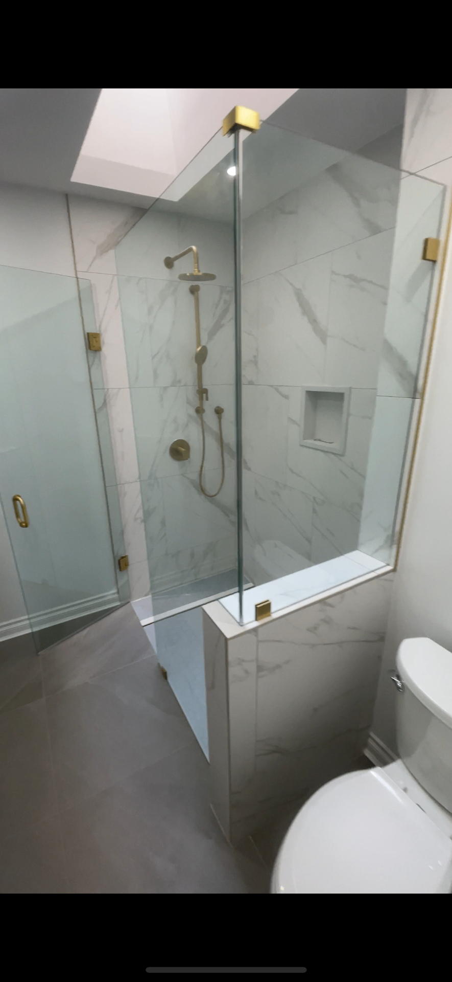 Marble shower with brass fixtures